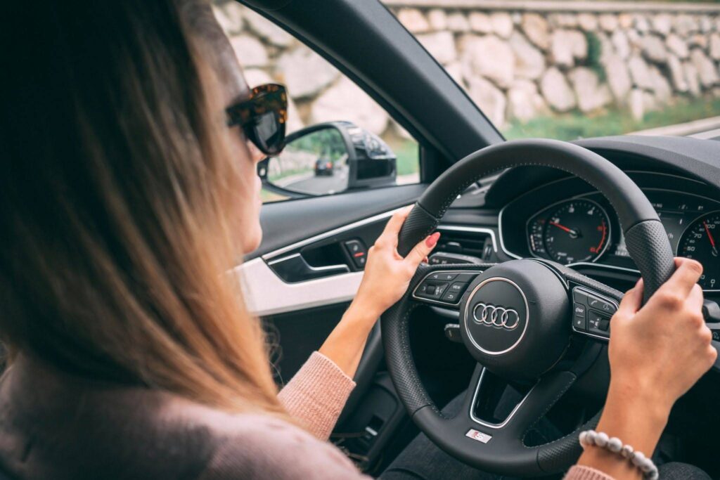 A driving student practicing to maintain speed in a car.
