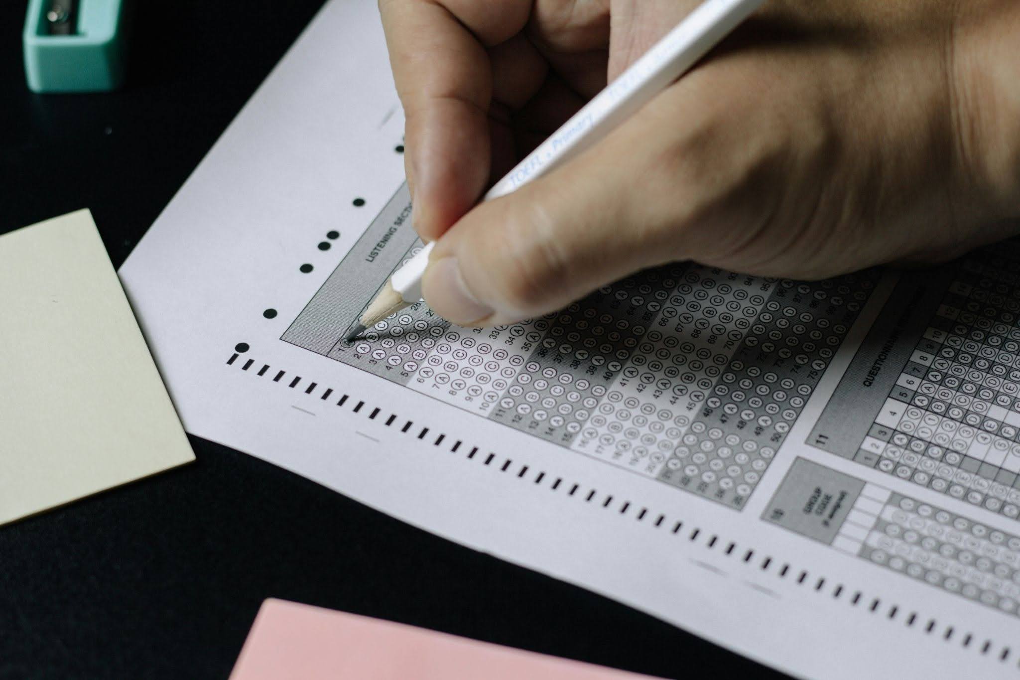 A person filling out road test for their driving license.
