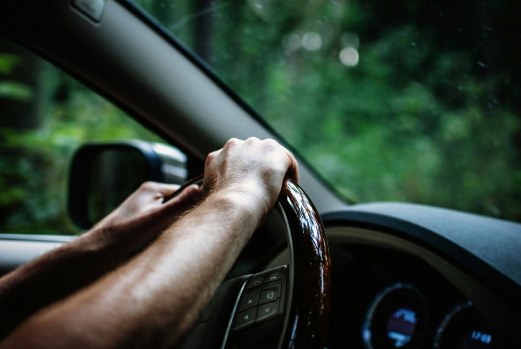A driving student learning to steer the wheel.