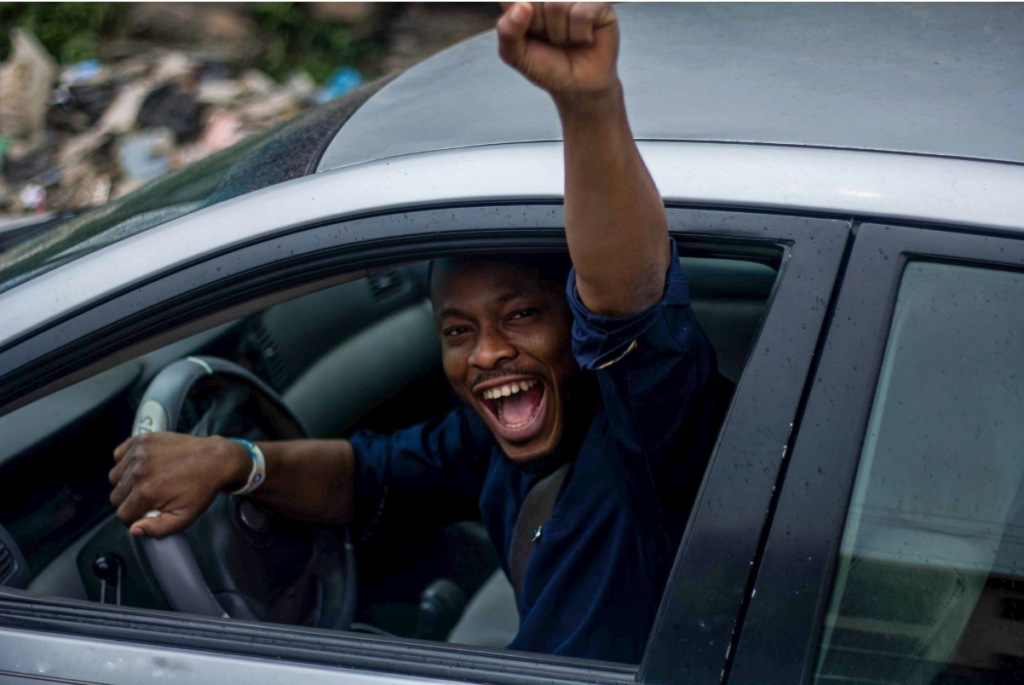 A man being happy for passing his driving test the first time.