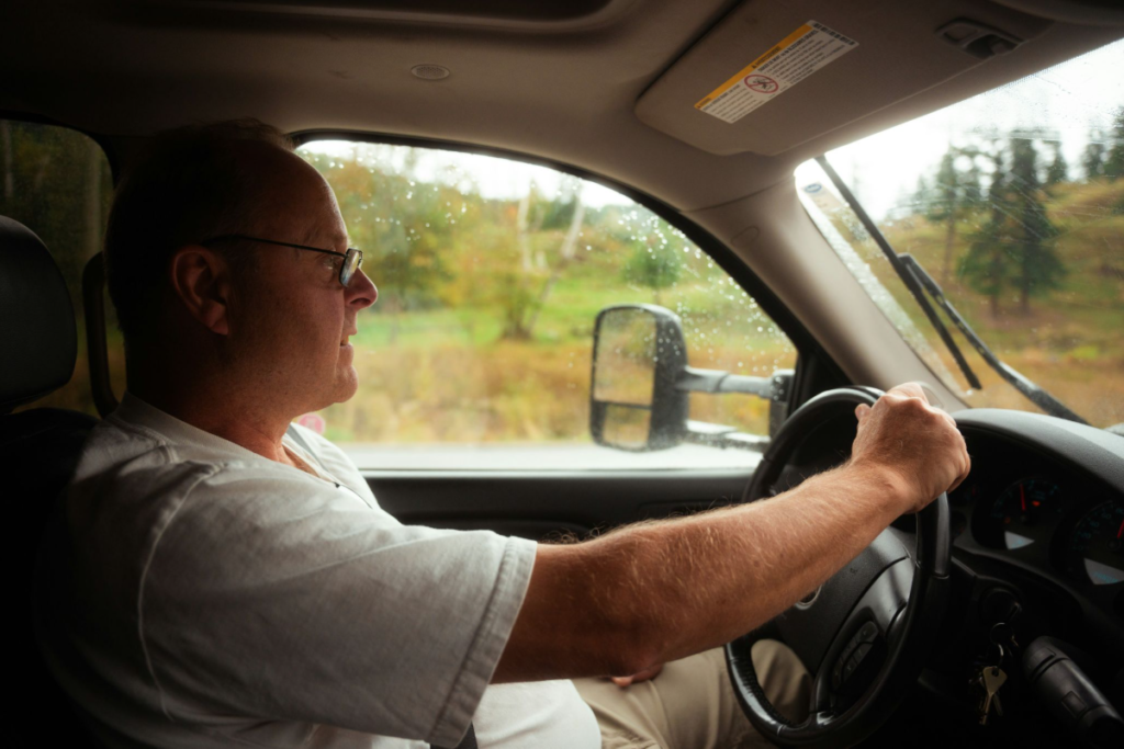 A senior driver driving a car.