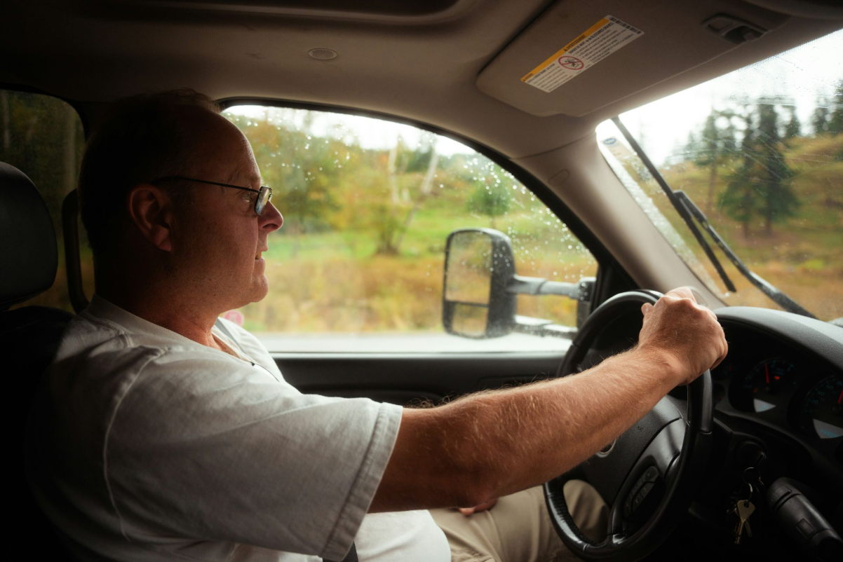 A senior driver driving a car.